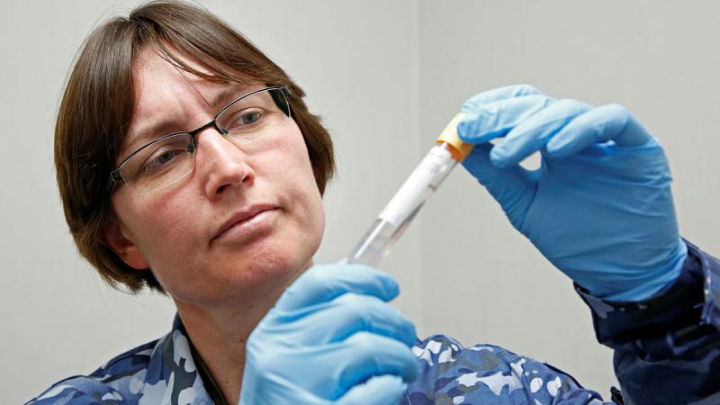 Air Force Specialist Reserve Forensic Doctor Flight Lieutenant Kirsty Wright with a sample for DNA testing Photo: Corporal Colin Dadd