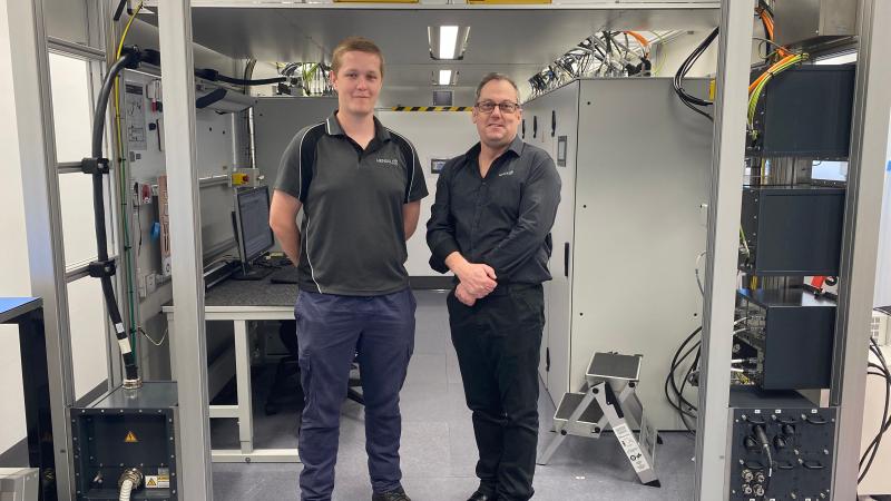 Leading Aircraftman Leigh Brettschneider (L) and his HENSOLDT Australia trainer Andrew Shegog at the operational maintenance trainer equipment room where trainees gain real-world experience on a working Airport Surveillance Radar - Next Generation.