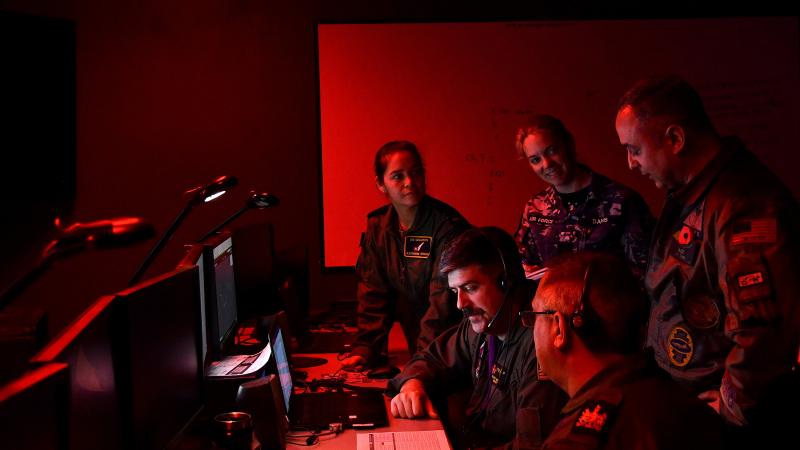 Taking part in Exercise RESOLUTE HUNTER at the Naval Aviation Warfighting Development Centre, at US Naval Air Station Fallon, Nevada, US. From left to right: Squadron Leader Katherine Wright (RAAF), Lieutenant Brady Martin (US Navy), Corporal Hayley Davis (RAAF), Warrant Officer Graham Davis (RAF), Commander Pete Salvaggio (US Navy). Photo: Lindsey Lauer