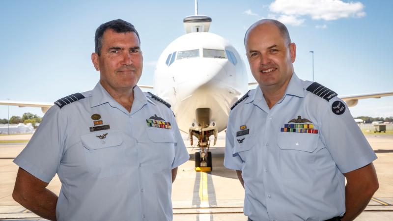 Incoming Officer Commanding 42 Wing, Group Captain James Parton (left) and outgoing Commander, Group Captain Angus Porter in front of a 2 Squadron E-7A wedgetail at RAAF Base Williamtown, NSW. Photo: Corporal Craig Barrett