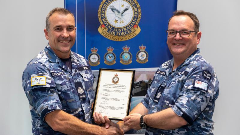 Warrant Officer Surveillance and Response Group (SRG), Warrant Officer Scott Doring, AM (right) hands over the reins of Warrant Officer SRG to Warrant Officer Russell Beck, CSC, OAM during the SRG Warrant Officer Hand Over Take Over Ceremony at RAAF Base Williamtown. Photo: LAC Samuel Miller