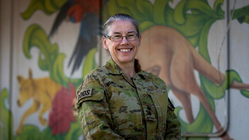 Australian Army Lieutenant Colonel Wendy Wheadon, Combined Joint Task Force - Operation Inherent Resolve Deputy Director of Sustainment, stands before the mural at Aussie House inside US military base Camp Arifjan, Kuwait. Photo: Corporal Jacob Joseph