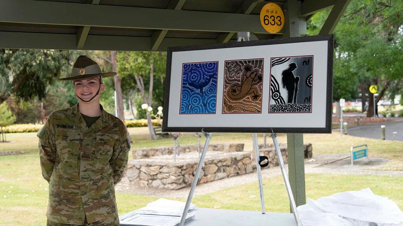 Private Kate Webster with her artwork “Nginhala Ngurambang” (Near Home), which now hangs in the Army Logistics Training Centre, Bandiana. Photo: Corporal Juliet Manalo