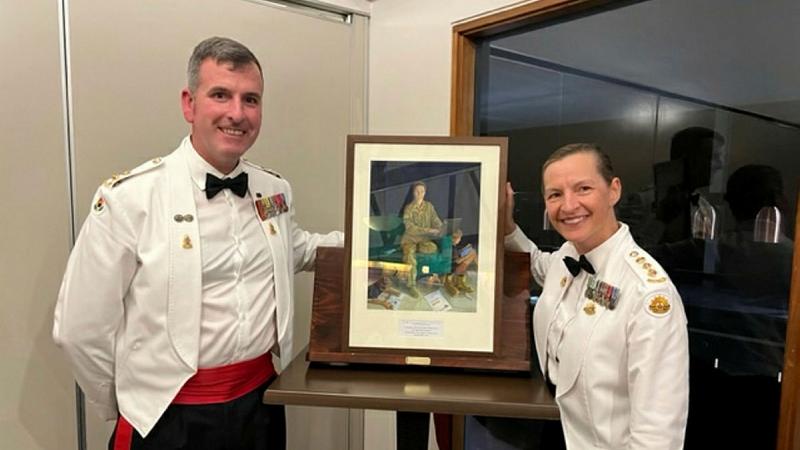 Colonel Clare Kellaway presents Lieutenant Colonel Scottie Morris with a painting by Anneke Jamieson. Photo: Major Mark Robinson