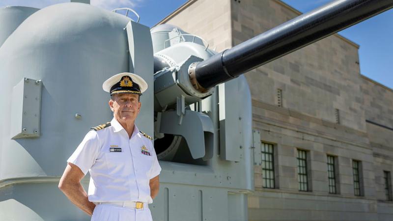 Caption: Curator and AWM Navy Fellow Commander Andrew Schroder stands in front of one of HMAS Brisbane’s 5-inch gun mounts as depicted in the online exhibition. Photo: Corporal Jacob Joseph