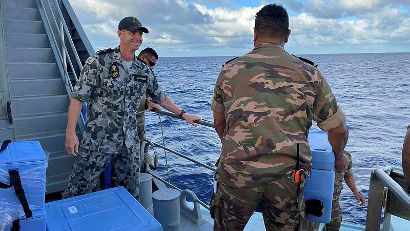 Chief Petty Officer Garry Danaher with a member of the Royal Tongan Navy aboard an Australian-gifted Guardian-class patrol boat, Tonga.