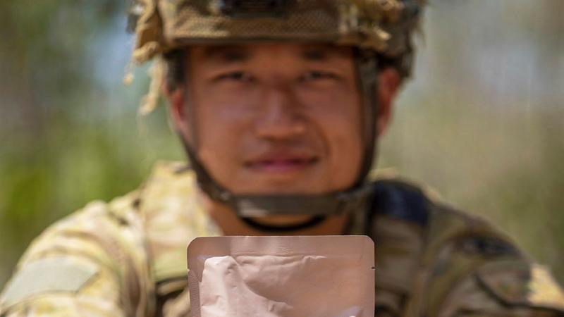 Private Johnny Huang, from 7RAR, holds a combat ration pack main meal at Mount Bundey training area. Photo: Corporal Jacob Joseph