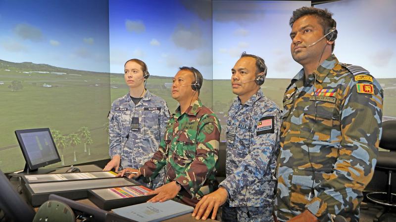 Flight Lieutenant Rhiannon Wares (RAAF), First Lieutenant Hery (Indonesia Air Force), Major Hafizul (Royal Malaysian Air Force), Squadron Leader Chamara (Sri Lanka Air Force), hone their instructional technique in the School of Air Traffic Control’s immersive tower visual simulator system at RAAF Base East Sale. Photo: Petty Officer Richard Prideaux.