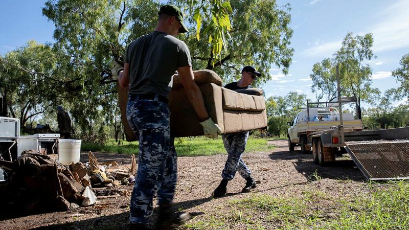 Members of Air Force’s 77 Squadron work to remove flood damaged items from affected properties in Fitzroy Crossing. Photo: Leading Aircraftwoman Kate Czerny