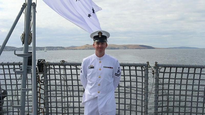 Petty Officer Adam O'Brien stands on the flight deck as HMAS Arunta pulls into Hobart ahead of the 185th Royal Hobart Regatta. Photo: Sub-Lieutenant Tahlia Merigan