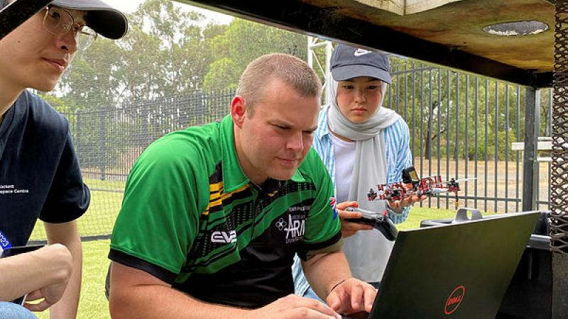 Sapper Alex Brown helps Year 10 student, Adiba to code her drone at RMIT’s Girls in Aerospace and Defence program in Bundoora.