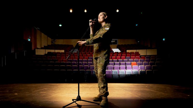 Squadron Leader Aleisha Croxford on stage at the Gungahlin College Theatre in Canberra. Photo: Private Nicholas Marquis