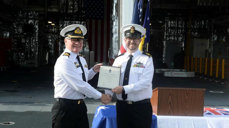 Washington Naval Attaché Commodore Darren Grogan, left, congratulates Warrant Officer Luke Brewer on his promotion on board USS Canberra. Photo: Mass Communication Specialist Second Class Vance Ha (US Navy)