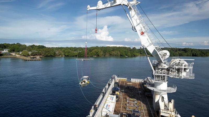 An Australian Army hydrographic vessel, from Littoral Riverine Survey Squadron, is hoisted into the water in Temotu Province, Solomon Islands. Photos: Leading Aircraftman Sam Price