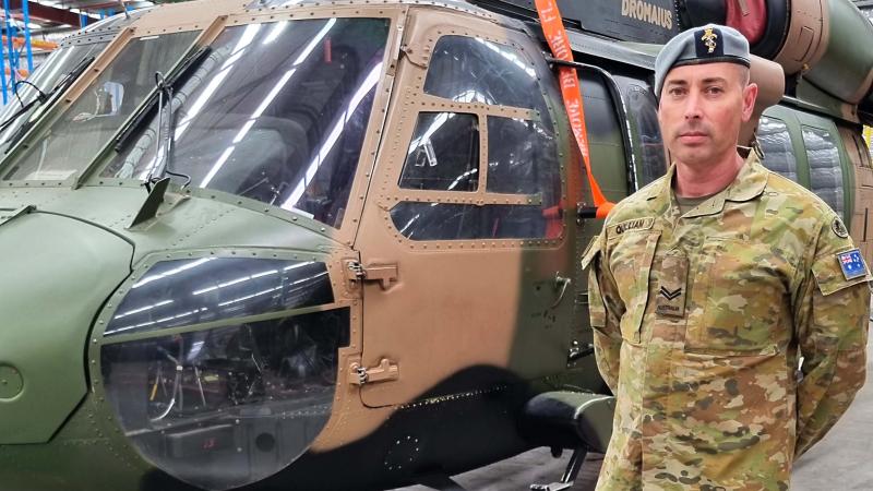 Corporal Paul Quilliam next to an old S70 Black Hawk at the Rotary-Wing Aircraft Maintenance School in Oakey.