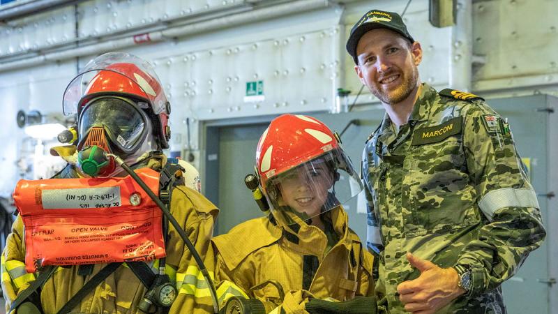 Lieutenant Commander Luke Marconi of HMAS Canberra shows damage control equipment to members of the public at HMAS Kuttabul's Open Day during Navy Week. Photos: Able Seaman Benjamin Ricketts