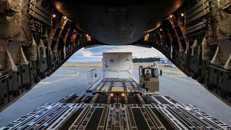 Leading Aircraftwoman Emma Nearmy from 29 Squadron removes Australian Antarctic Division cargo from a C-17A Globemaster III at Hobart International Airport, Tasmania. Photos: Corporal Lisa Sherman