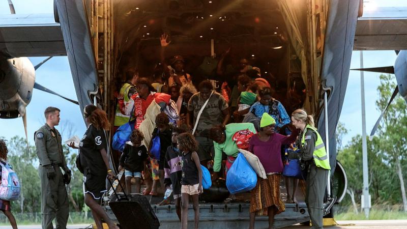 Air Force personnel assist residents as they are evacuated from the Kalkarindji area in the Northern Territory. Photos: Corporal Ashley Gillett