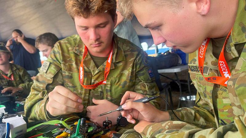 Australian Army Cadets, Sergeant Kyle Croghan, left, and Corporal Lewis Sanderson repair a racing drone at the 2023 Avalon International Airshow. Photo: Warrant Officer – Class 2 Mick Davis
