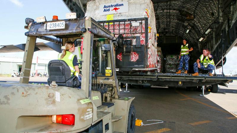 Mobile air logistics team members from 22 Squadron unload pallets of Australian aid from an Air Force C-17A Globemaster III at Port Vila, Vanuatu. Photo: Sergeant David Gibbs