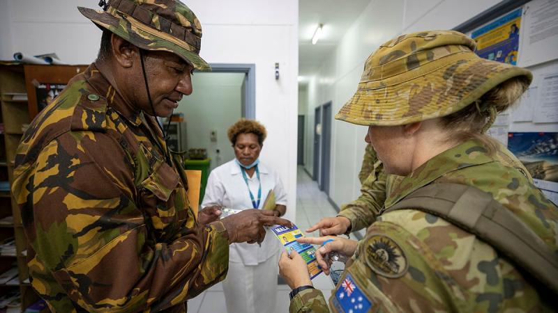 Australian Army medic Sergeant Kathleen Cole speaks with Papua New Guinea Defence Force Warrant Officer Class 2 Jerry Aini at Murray Barracks Health Centre, Port Moresby. Photo: Corporal Brandon Grey