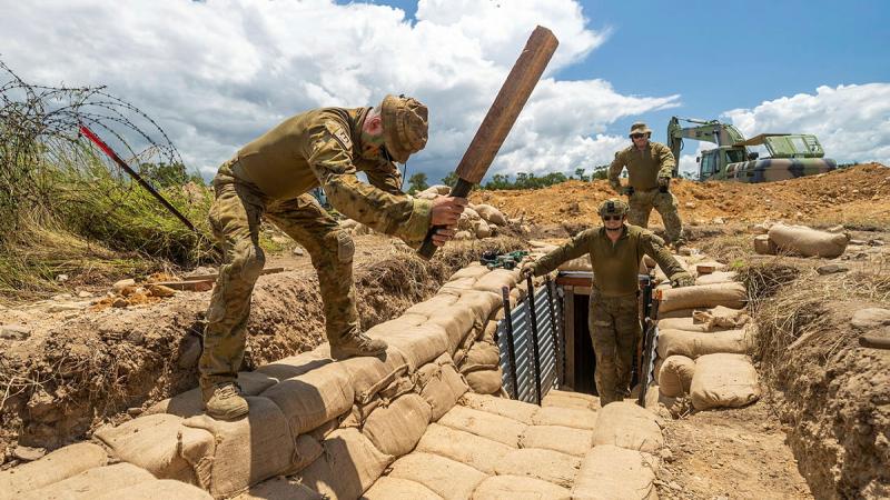 Sapper Dean Ridgeway from the 3rd Combat Engineer Regiment tamps sandbags during a trench construction activity in Townsville. Photos: Sergeant Brodie Cross