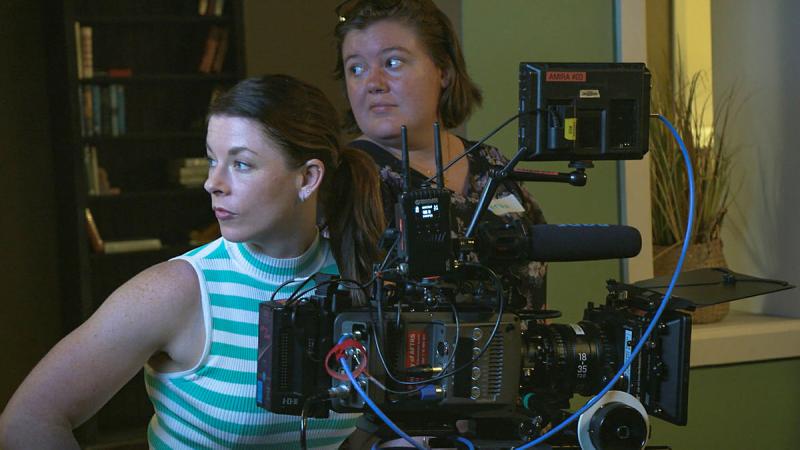 Lieutenant Commander Claire Baldwin, left, from the Directorate Navy Culture, takes control of the camera during the Screen Warriors training program.