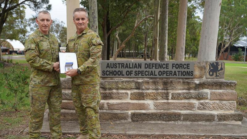 Major General Paul Kenny, left, Special Operations Commander for Australia, presents Major Paul Dunbavin from the Australian Defence Force School of Special Operations with his Chief of Army gold commendation at Holsworthy Barracks, Sydney. 