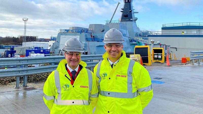 The new Australian Naval Adviser to London Captain Adrian Capner, right, with the previous adviser Captain Paul Mandziy at BAE Systems global combat ship facility in Glasgow, Scotland.