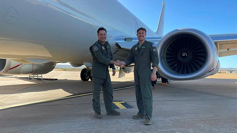 Warrant Officer Paul Gregory, left, with Flight Lieutenant Bradley McMaster, celebrates achieving over 9,000 flying hours of service.