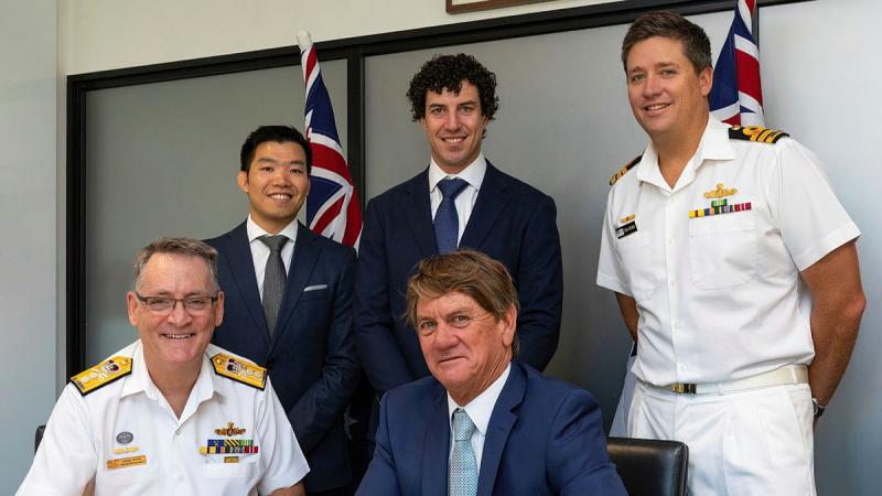 Rear Admiral Steven Tiffen, front left, signs a contract with Noakes Group Managing Director Sean Langman, front right, with members from Mine Warfare and Clearance Diving Systems Program Office and Noakes Group. Photo: Able Seaman Benjamin Ricketts