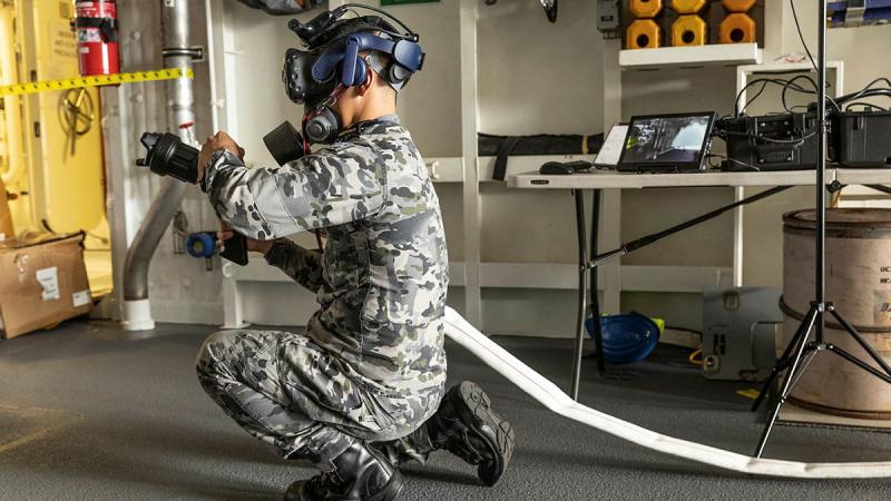 Able Seaman Kevin Tran uses the virtual reality damage control system on board HMAS Brisbane at Fleet Base East, Sydney. Photos: Able Seaman Allanson