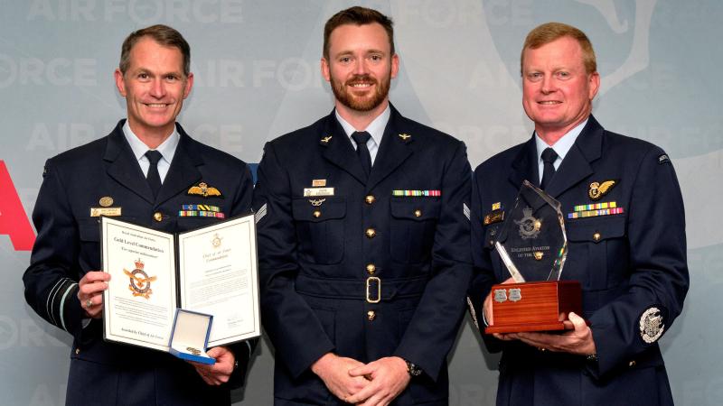 Warrant Officer of the Air Force Ralph Clifton (right) along with the Chief of Air Force, Air Marshal Robert Chipman (left) presents the Enlisted Aviator of the Year Award to Corporal Jack Simpson at a reception commemorating the 102nd anniversary of the formation of the Royal Australian Air Force at the Australian War College, Weston, ACT.  Photo: Flight Sergeant Kev Berriman