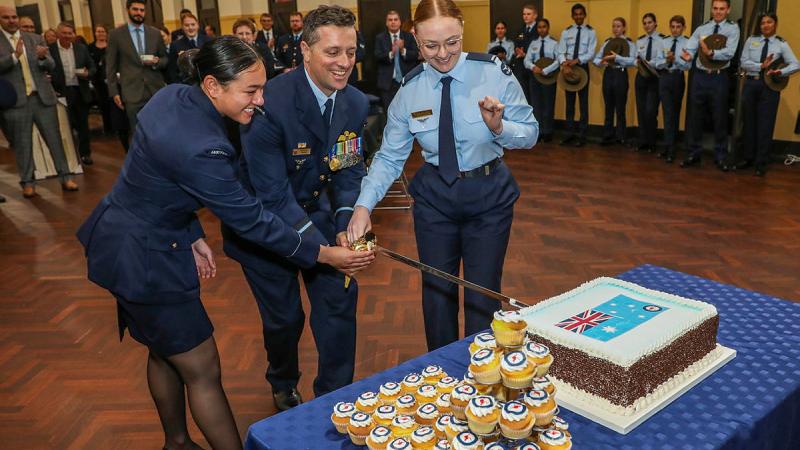 Senior Australian Defence Force Officer Edinburgh, AIRCDRE Adrian Maso, Flying Officer Trish Noah and ACW Emily Wellington cut the cake to mark the 102nd anniversary of the formation of the RAAF. Photo: Corporal Brenton Kwaterski