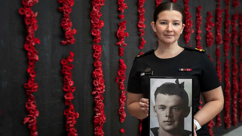 Sub-Lieutenant Mary Booth holds a portrait of her great uncle Able Seaman Ernest Albert Booth at the Australian War Memorial in Canberra. Photos: Corporal Luke Bellman