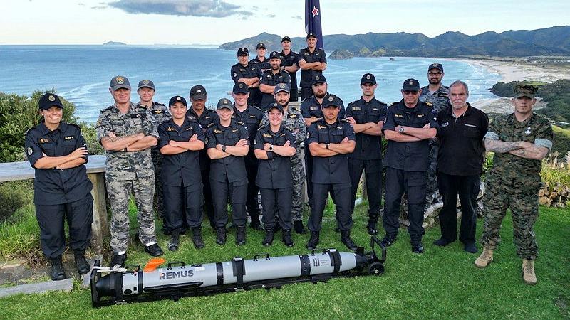 Members of the RAN Maritime Geospatial Warfare Unit join with members of the RNZN and US Marine Corps with a REMUS 300 autonomous undersea vessel at Great Barrier Island, NZ.