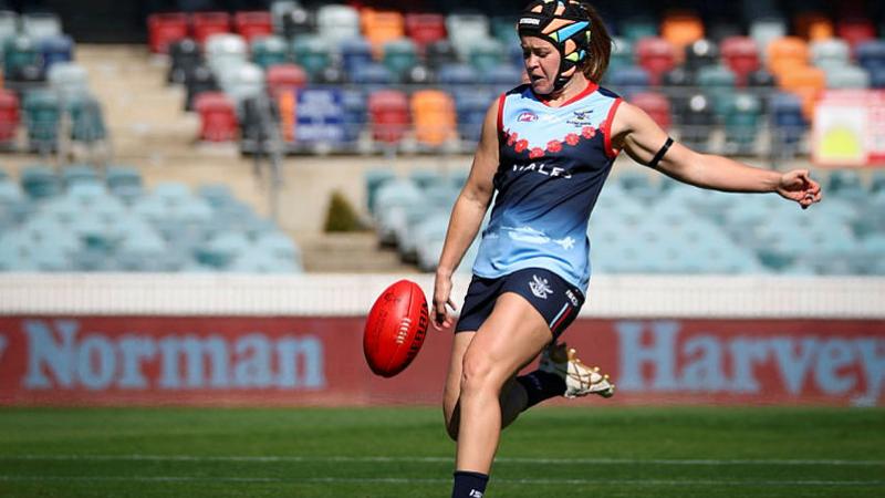 ADF Women's All Star and Australian Army Corporal, Elisha Gallagher, kicks a forward 50 entry against the NSW Police Force women's team, as part of the AFL Anzac Round at Manuka Oval, Canberra. Photo: Corporal Lisa Sherman