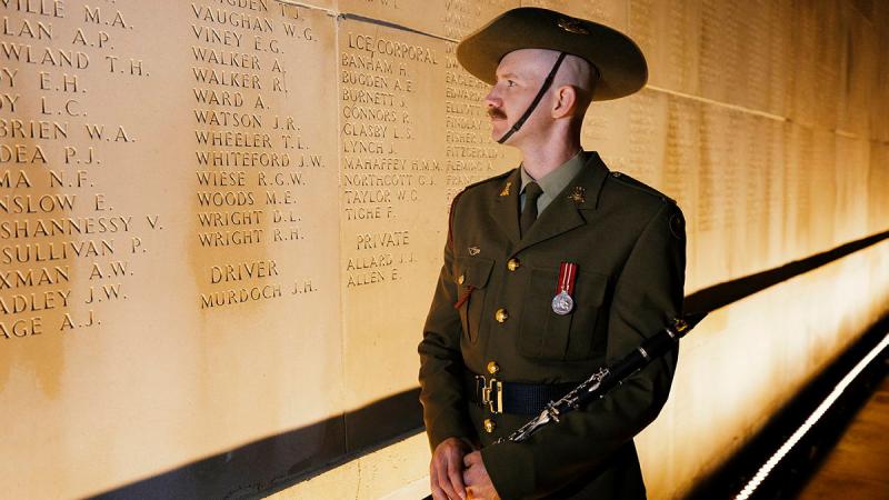 Musician Scott Collinson stands beside the name of his relative, Private Alexander Walker, prior the Anzac Day Dawn Service at the Australian National Memorial in Villers-Bretonneux, France. Photo: Sergeant Oliver Carter.
