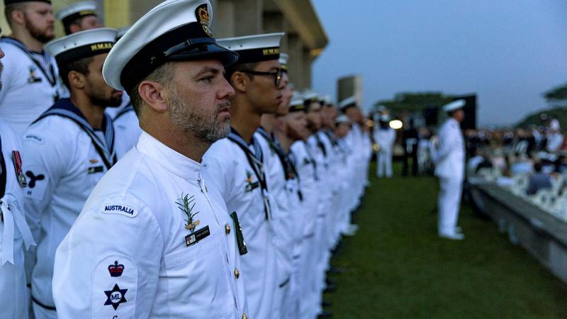 HMAS Anzac sailor Petty Officer Ryan Kuipers stands at ease during a dawn service at the Kranji War Cemetery and Memorial, Singapore. Photos: Leading Seaman Jarryd Capper