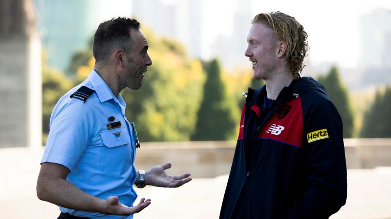Flight Lieutenant Adon Lumley chats with Clayton Oliver from the Melbourne Football Club for Anzac day at The Shrine of Remembrance, Melbourne. Photo: Leading Aircraftman Ryan Howell