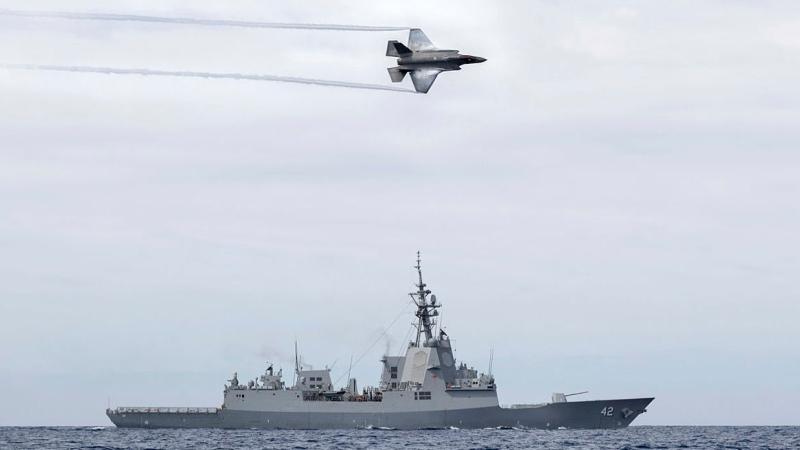 A Royal Australian Air Force F-35A Lightning II aircraft conducts a flypast over HMAS Sydney during Exercise Tasman Shield. Photo: Able Seaman Joshua Bishenden