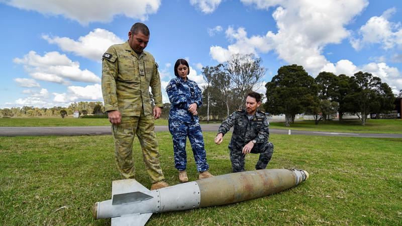 From left, Combat Engineer Sergeant Kieron Day, Armament Technician Corporal Bethany Magner and Chief Petty Officer Clearance Diver Ben Beck discuss task management munition configurations. Photo: Corporal Randall Costello