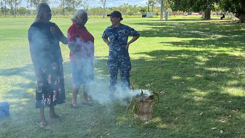 Indigenous Elders from the Fitzroy Crossing community with RAAF Indigenous Liaison Officer, Flight Lieutenant Tramaine Dukes, during a smoking ceremony at Fitzroy Crossing in the Kimberley Region, WA.