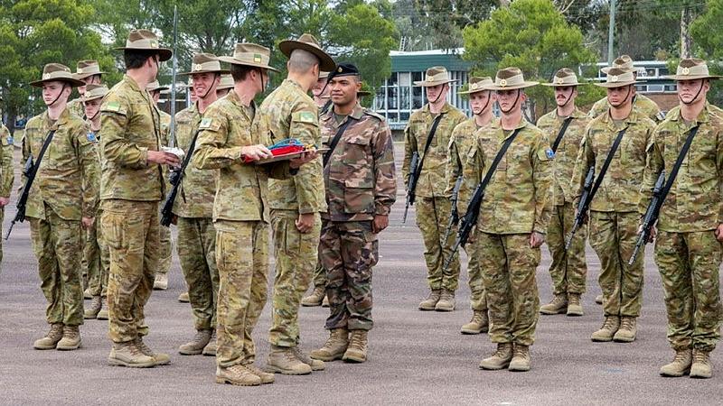 Private Barnabas Kolamatangi speaks with Lieutenant Colonel Richard Thapthimthong after graduating from the School of Infantry Initial Employment Course, Singleton.