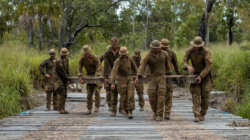 Sappers remove timber planks from Elanora Bridge to lay high explosive charge in preparation for demolition during Exercise Terrier Walk at Shoalwater Bay Training Area. Photos: Corporal Nicole Dorrett