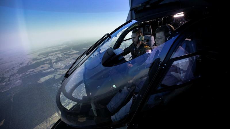  Lieutenant Cody Sinclair instructs Roger Campbell, a winner of the Variety flight simulator experience, at 723 Squadron HMAS Albatross. Photos: Petty Officer Kayla Jackson