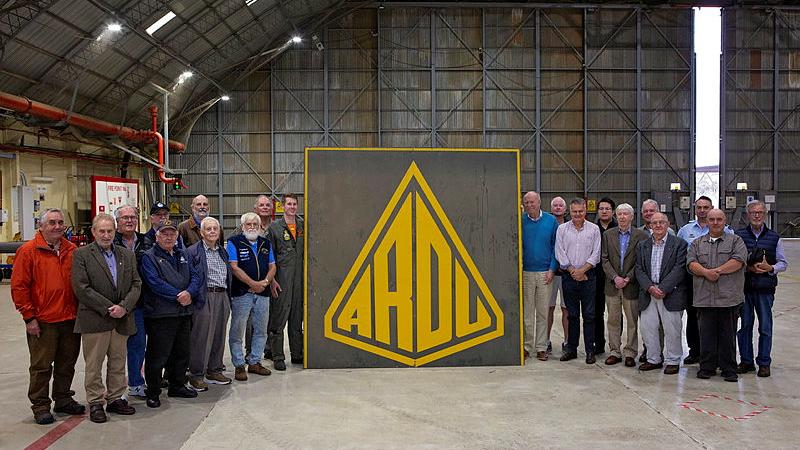 Flight Commander ARDU - Edinburgh, Squadron Leader Dawson Schuck (centre left), donates the old ARDU hangar sign to the President of the South Australian Aviation Museum, Nigel Daw (centre right), during the visit to RAAF Base Edinburgh, South Australia. Photo: Sergeant Nicci Freeman