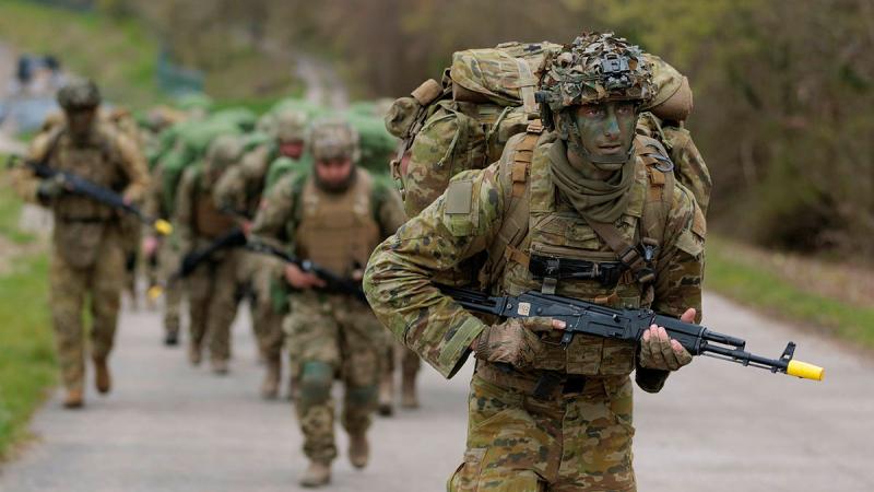 Australian Army soldiers deployed on Operation Kudu lead recruits from the Armed Forces of Ukraine as they march to a field training area in Southern England. Photos: Sergeant Andrew Sleeman