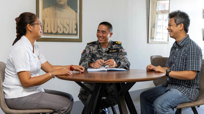 Royal Australian Navy Liaison Officer Philippines, Lieutenant Paolo De Leon, briefs Australian embassy defence section staff on upcoming logistic requirements. Photo: Leading Seaman Nadav Harel