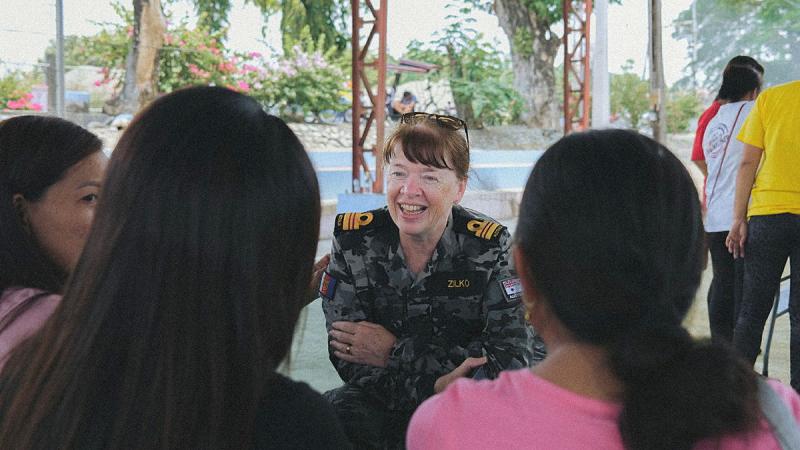 Royal Australian Navy officer Lieutenant Commander Alison Zilko talks with locals about women and families, peace, and security during Exercise Balikatan 2023. 
